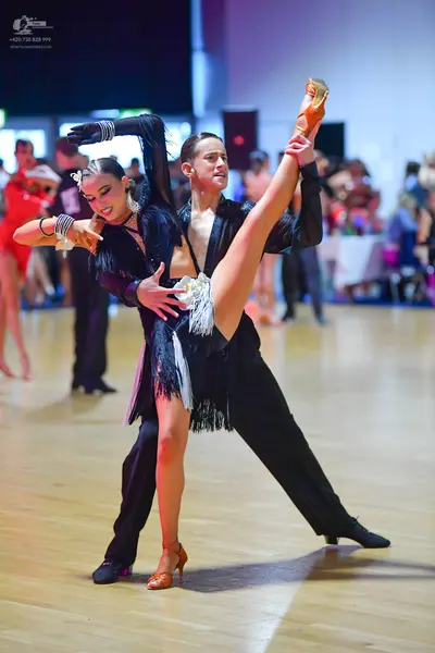 Dancesport competitor: Male dancer: black long-sleeved shirt and black trousers