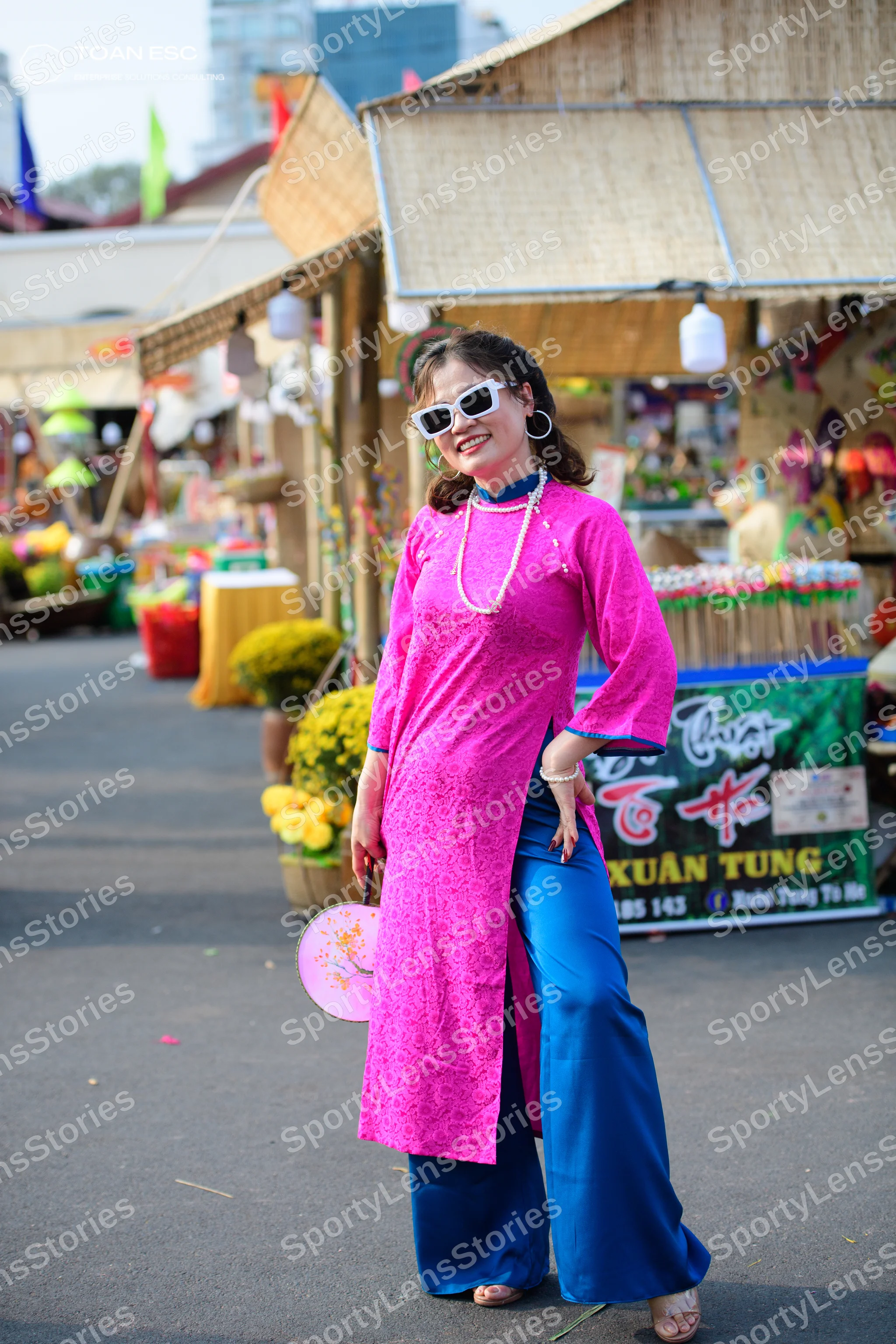 Dancesport competitor: Female dancer: bright pink lace long tunic with high side slits, blue satin trou
