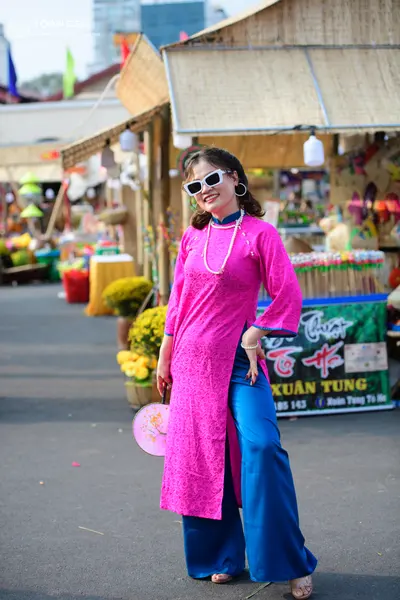 Dancesport competitor: Female dancer: bright pink lace long tunic with high side slits, blue satin trou