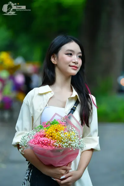 Dancesport competitor: Female dancer: cream-colored button-down shirt over a white top and dark bottoms