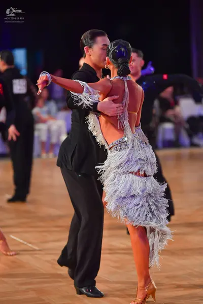 Dancesport competitor: Male dancer: black long-sleeved top and black trousers