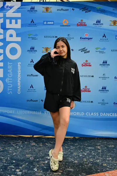 Dancesport competitor: Female dancer: black long-sleeved zip-up jacket and black shorts