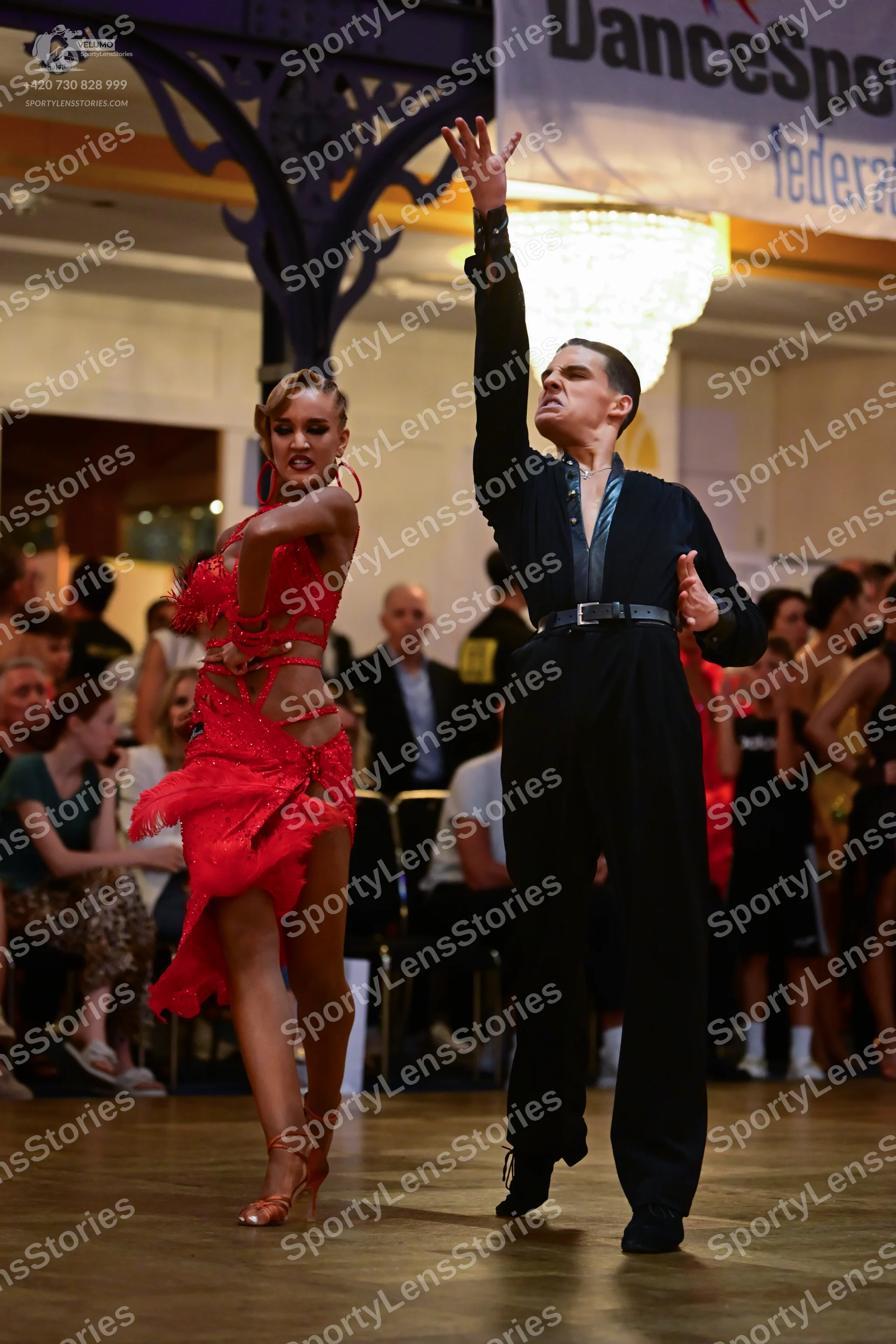 Dancesport competitor: Male dancer: black long-sleeved dance top and trousers with a satin-like panel o