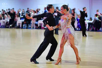 Dancesport competitor: Male dancer: black long-sleeved shirt and black trousers