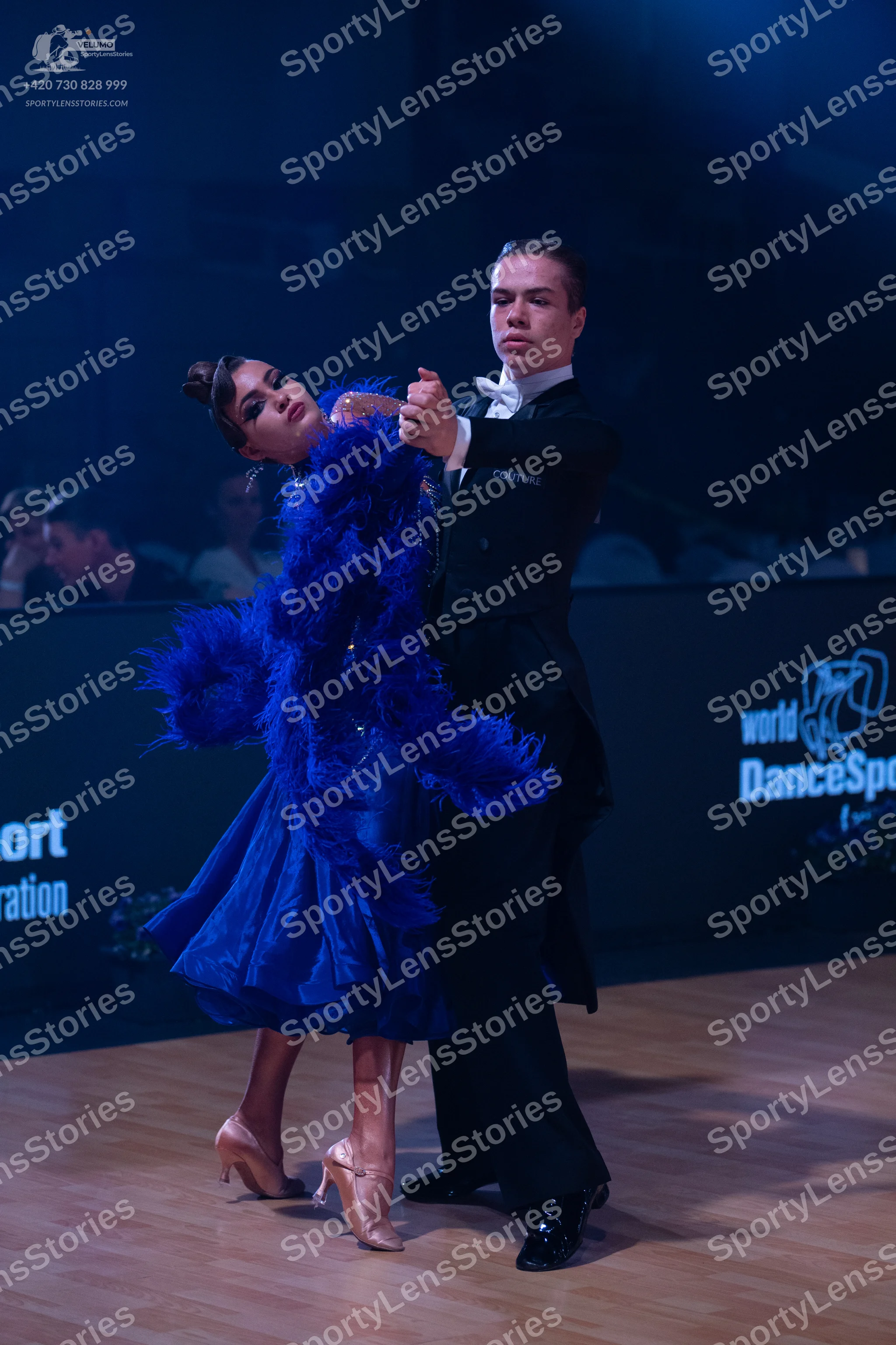 Dancesport competitor: Male dancer: black ballroom suit with a white shirt and white bowtie