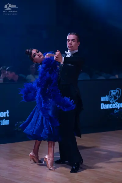 Dancesport competitor: Male dancer: black ballroom suit with a white shirt and white bowtie