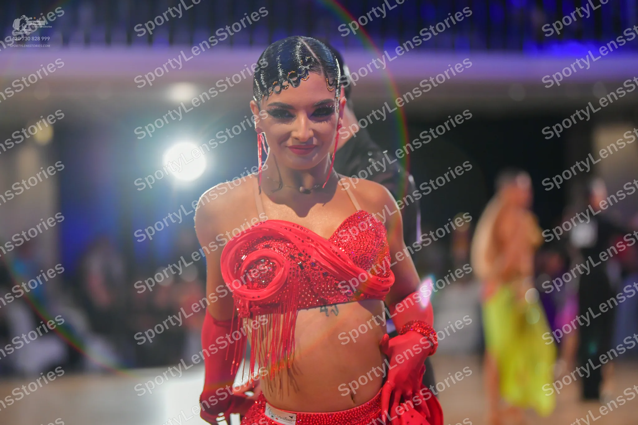 Dancesport competitor #73: Central female dancer: red sequin latin top with long fringe, matching red sequi