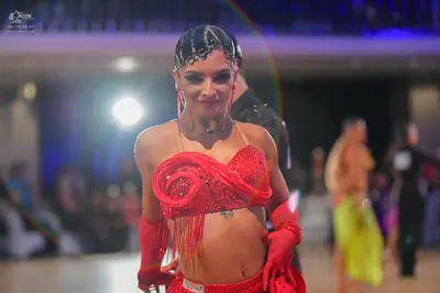 Dancesport competitor #73: Central female dancer: red sequin latin top with long fringe, matching red sequi