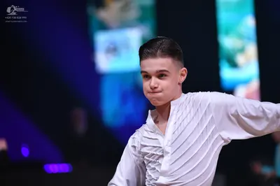 Dancesport competitor: Male dancer: white long-sleeved shirt with vertical textured or pleated patterns