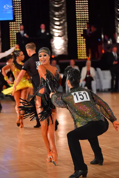 Dancesport competitor #151: Male dancer: dark, iridescent, sequined long-sleeve shirt and black trousers