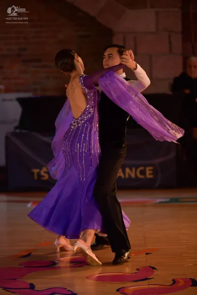 Dancesport competitor: Male dancer: black waistcoat, black trousers, and a white long-sleeved shirt