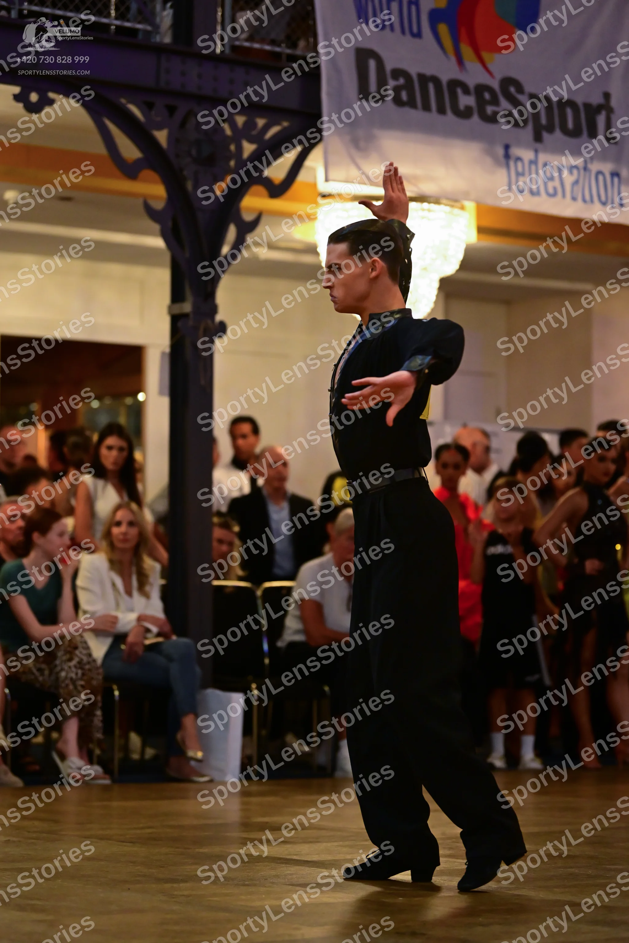 Dancesport competitor: Male dancer: black long-sleeved shirt and black trousers