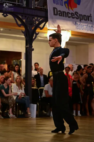 Dancesport competitor: Male dancer: black long-sleeved shirt and black trousers