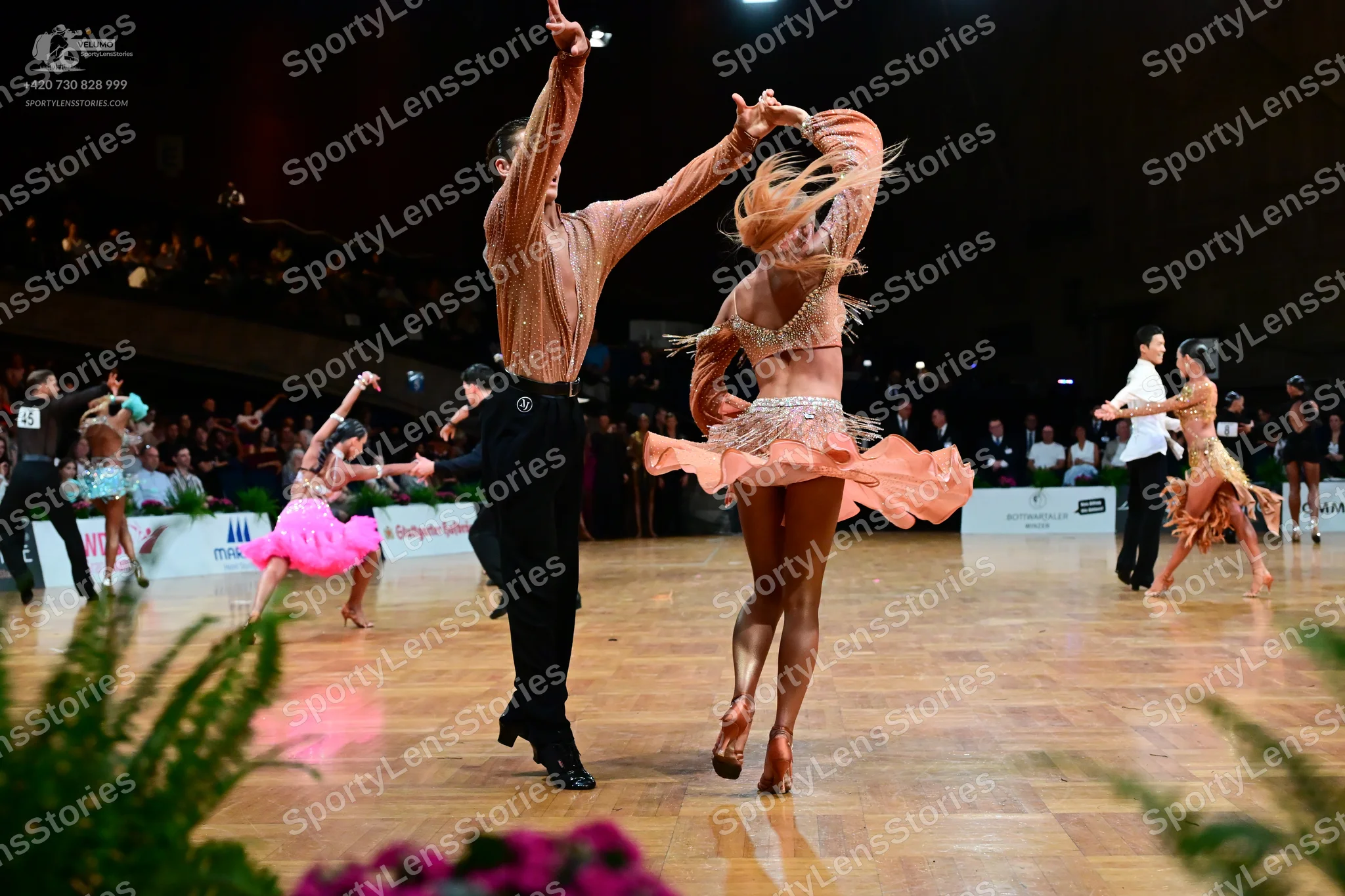 Dancesport competitor: Male dancer (center): champagne-colored long-sleeved shirt and black trousers
