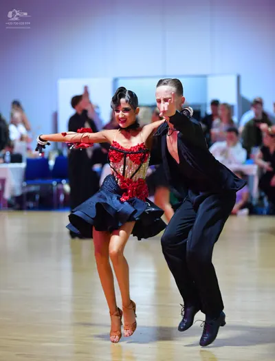 Dancesport competitor: Male dancer: black long-sleeved shirt and black trousers