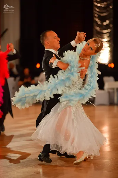 Dancesport competitor: Male dancer: black suit with a white shirt