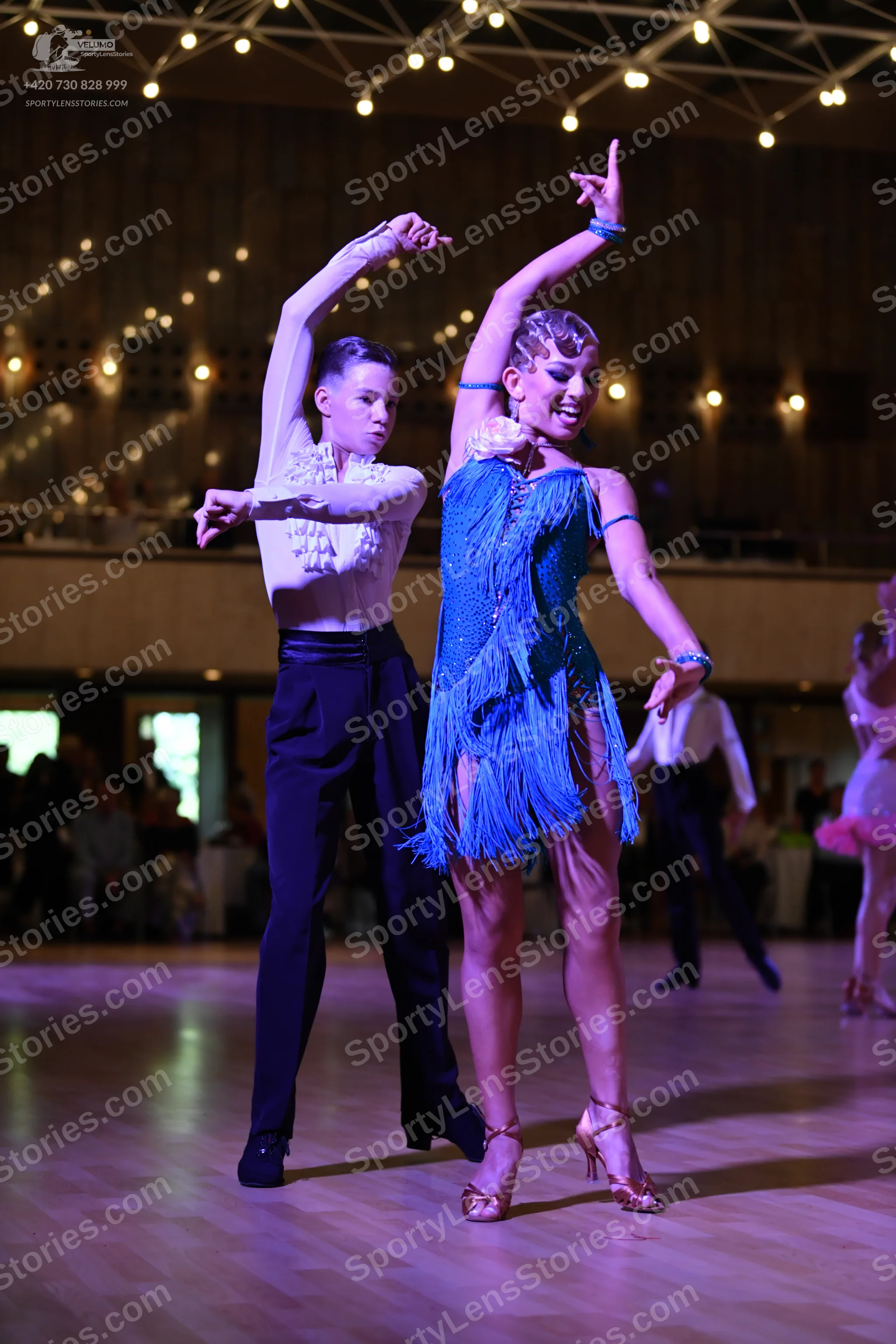 Dancesport competitor: Male:** Black fitted suit with silver sequin lapels and cuffs