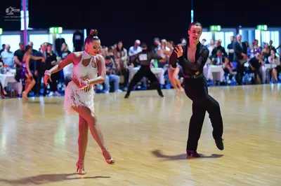 Dancesport competitor: Female dancer: white latin dress with fringe-like texture