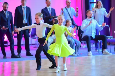 Dancesport competitor: Male dancer: white long-sleeved shirt, black trousers, and a black bowtie