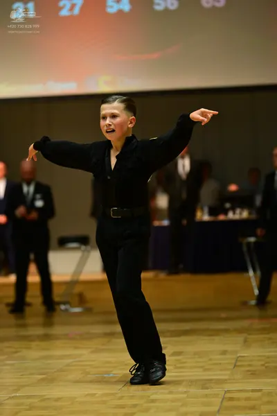 Dancesport competitor: Male dancer: black long-sleeved shirt and black trousers