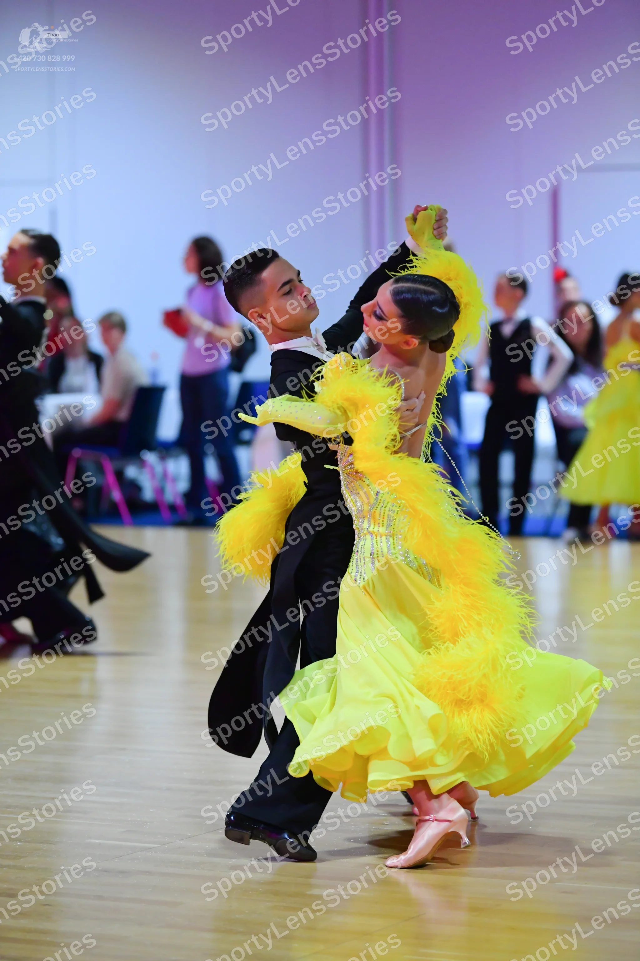 Dancesport competitor: Male dancer: black tailcoat suit with black trousers and black dance shoes