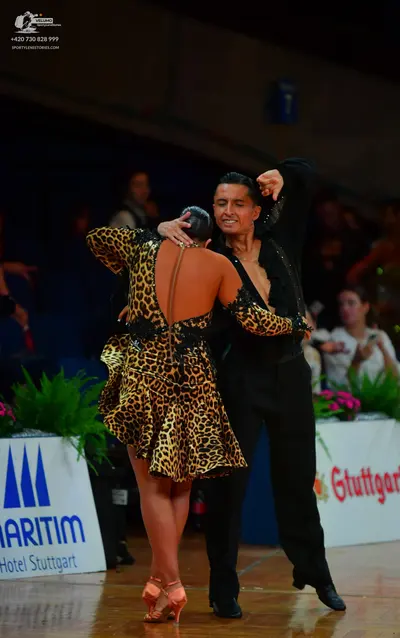 Dancesport competitor: Female dancer: leopard print Latin dress with long sleeves and an open back