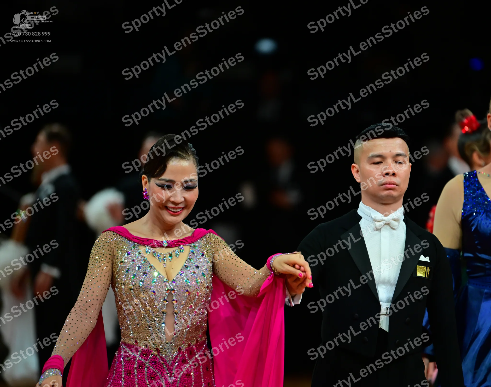 Dancesport competitor: Main female dancer: pink and nude Latin dress heavily embellished with silver se