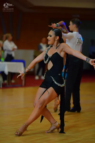 Dancesport competitor #302: Female dancer: black Latin dress with silver rhinestone embellishments and long 
