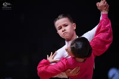 Dancesport competitor: Male dancer: white long-sleeved shirt and dark trousers