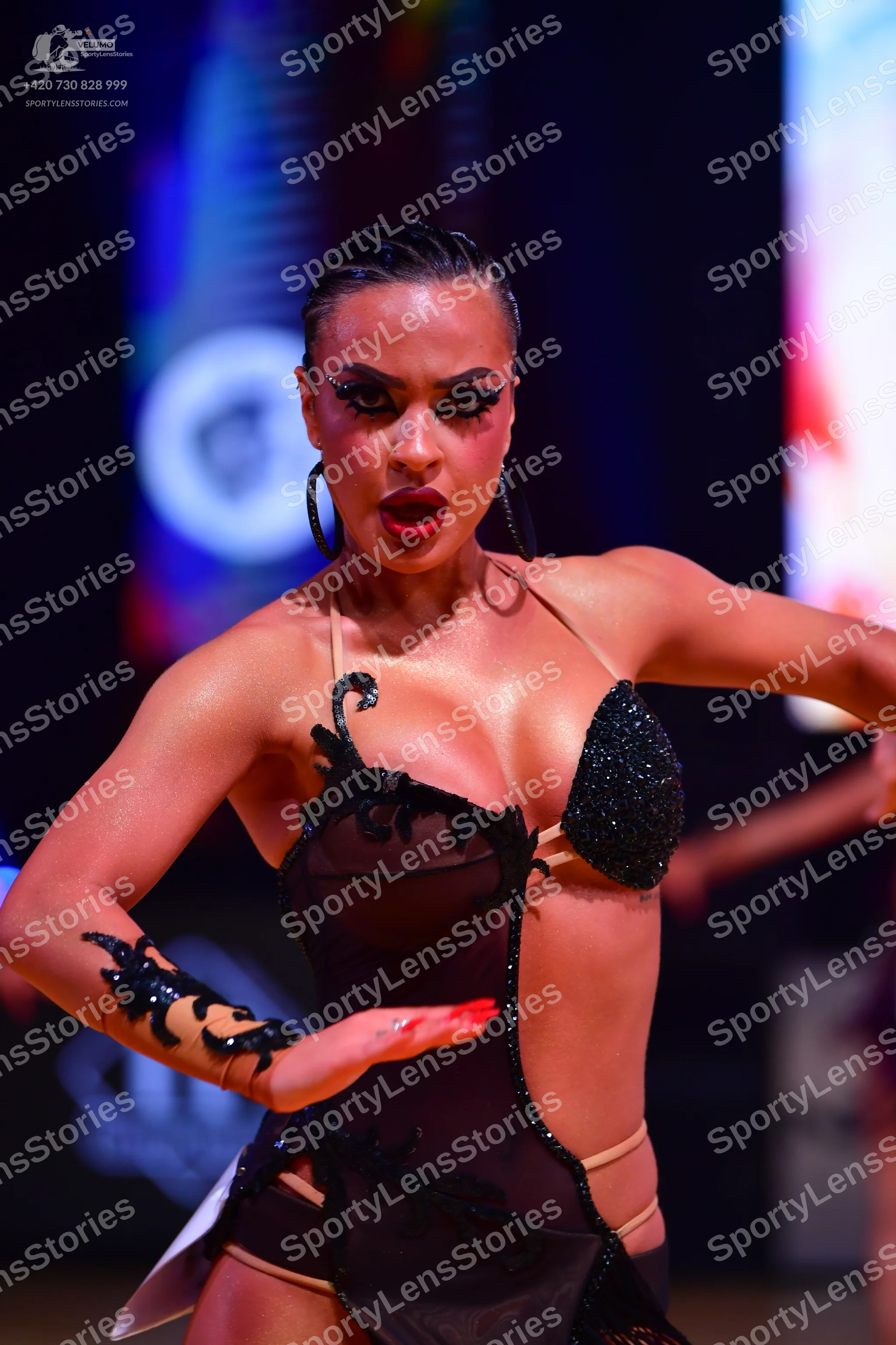 Dancesport competitor: Female dancer: black and nude-colored Latin dance costume with sheer mesh, black