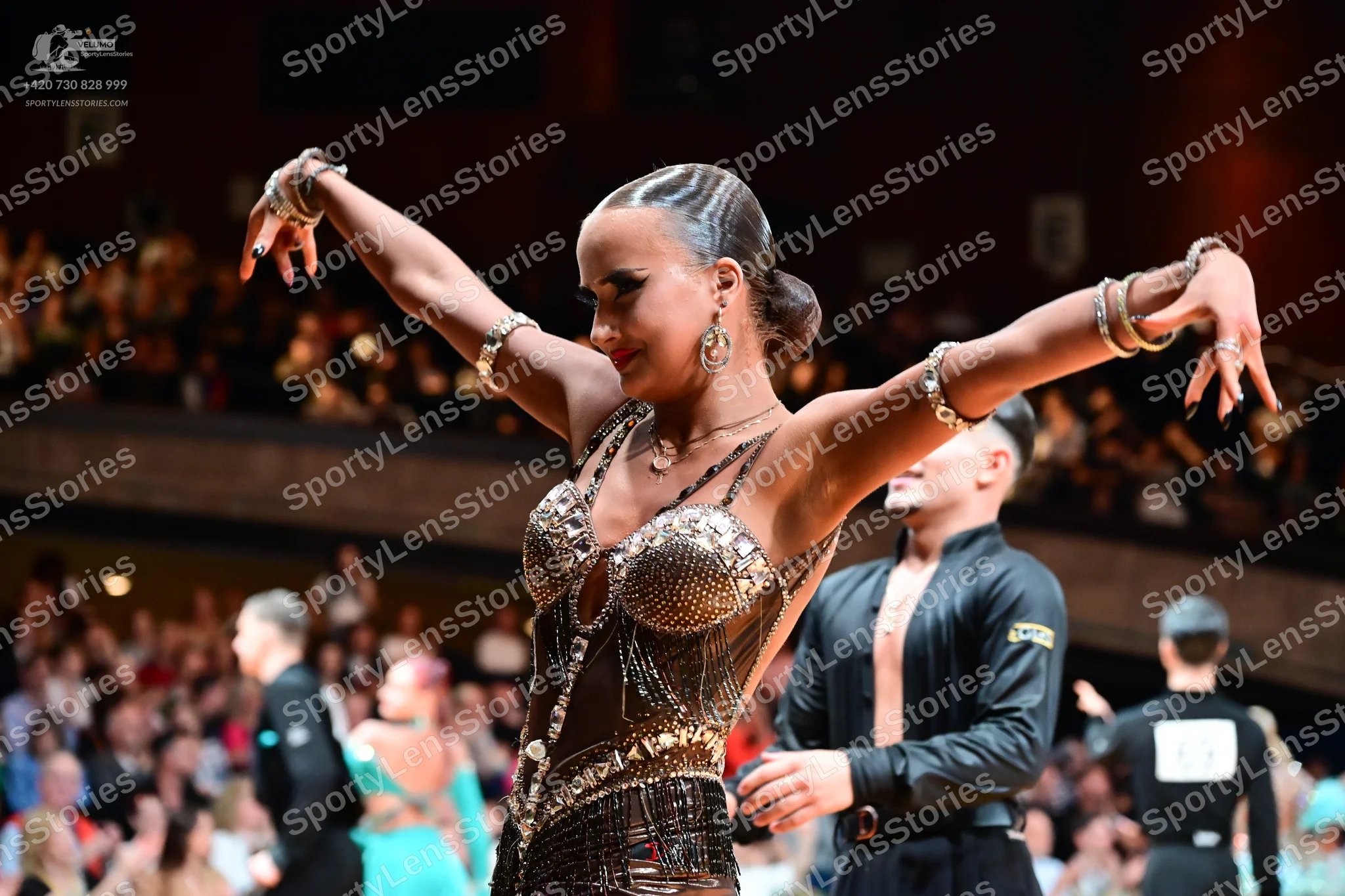 Dancesport competitor: Main female dancer: Bronze/gold Latin dance bodysuit heavily embellished with se