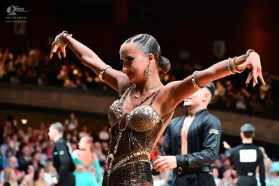 Dancesport competitor: Main female dancer: Bronze/gold Latin dance bodysuit heavily embellished with se