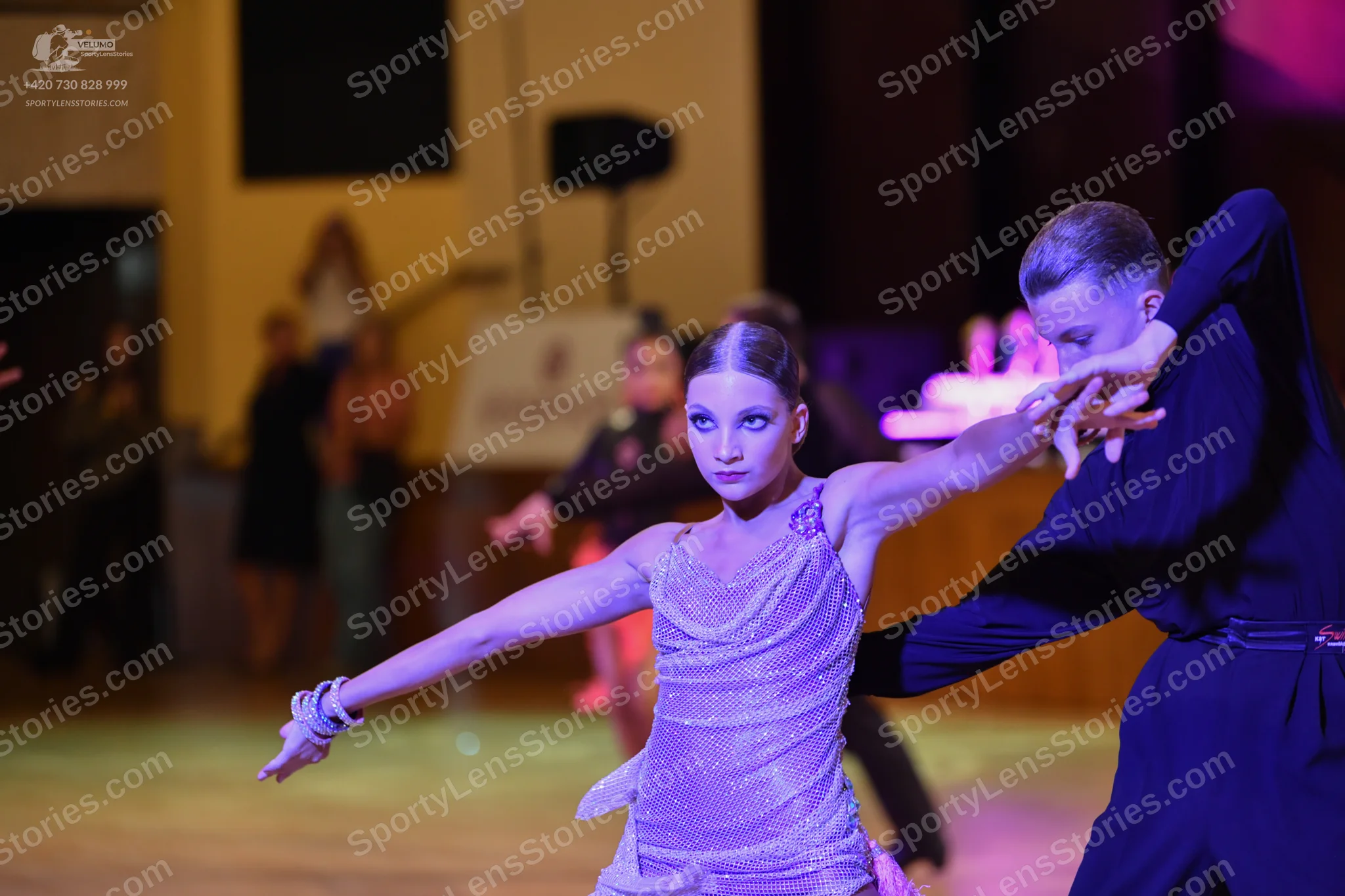 Dancesport competitor: Male: Black tail suit with silver sequin accents on the lapels