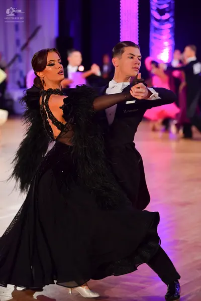 Dancesport competitor: Male dancer: black formal suit with a white shirt