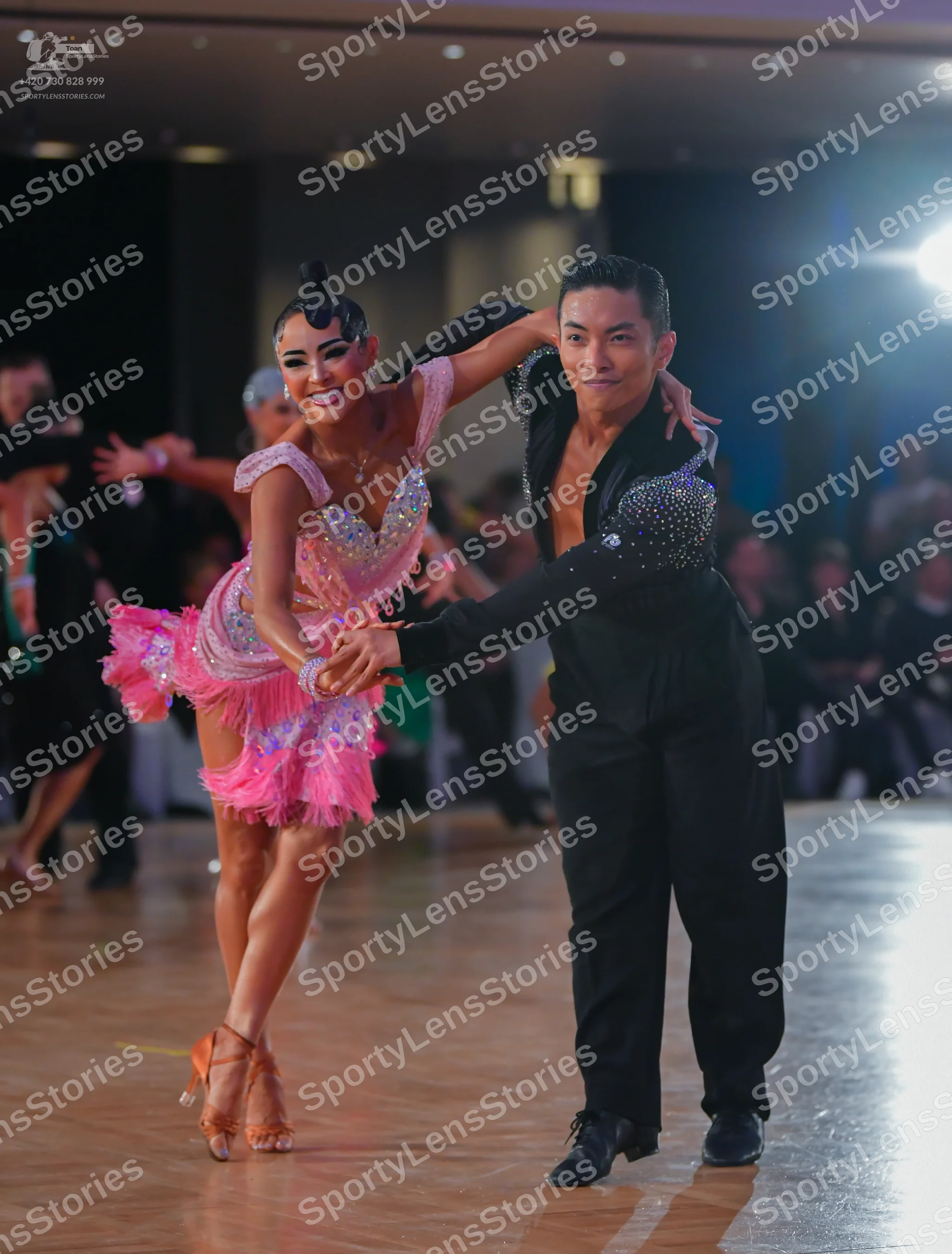 Dancesport competitor: Male dancer: black long-sleeved shirt with sequins on the upper chest and black 