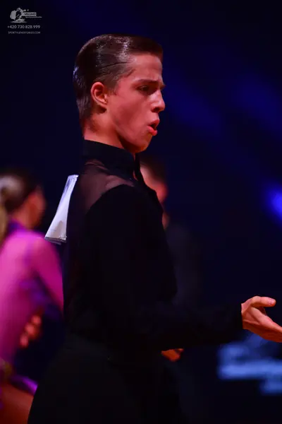 Dancesport competitor: Male dancer: black long-sleeved top