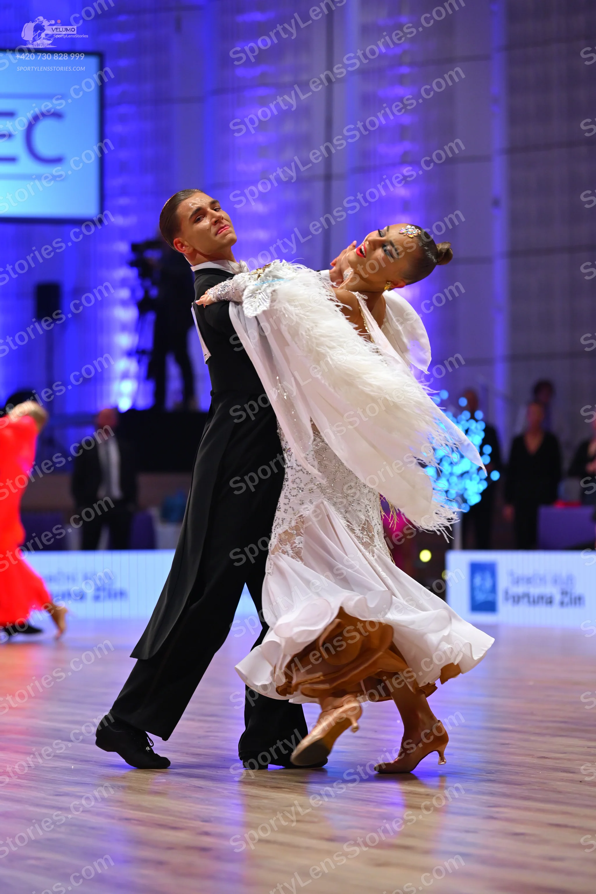 Dancesport competitor: Male dancer: black tailcoat-style suit and black trousers