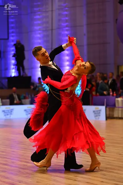 Dancesport competitor: Male dancer: black suit with a white shirt and black bowtie