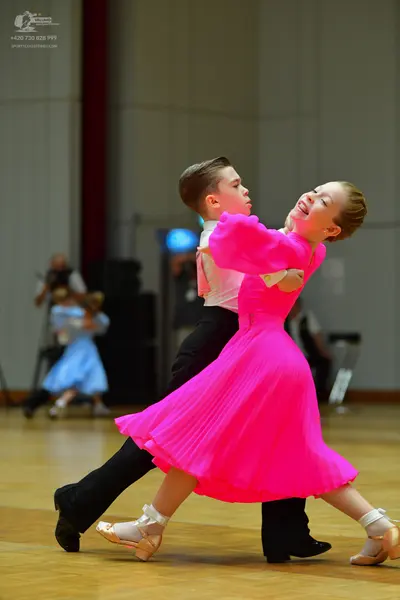 Dancesport competitor: Male dancer: white long-sleeved shirt and black trousers