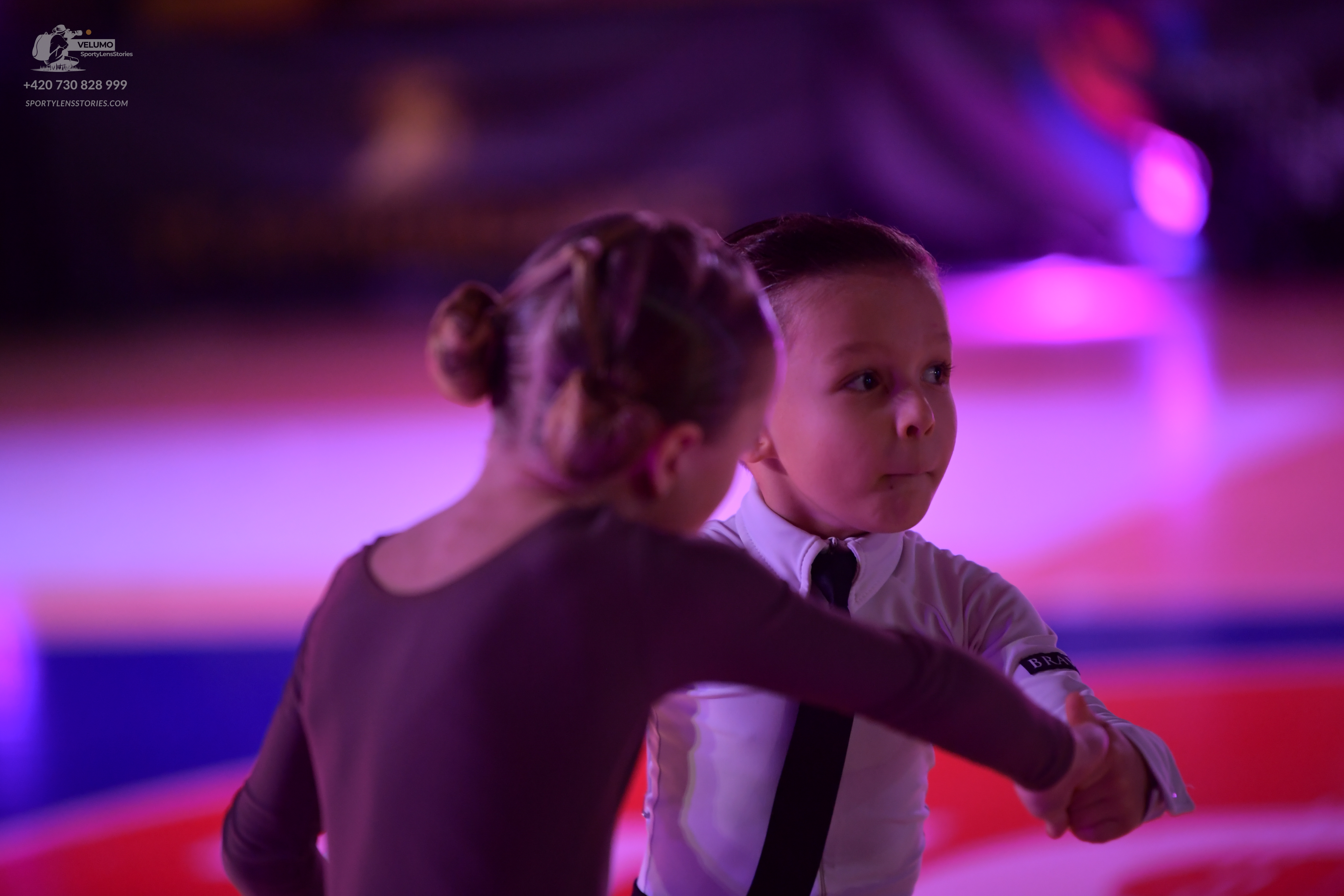 Dancesport competitor: Female dancer: dark brown long-sleeved bodysuit