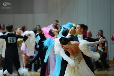 Dancesport competitor #75, #73: Male dancers: black suits, one with a white shirt and white bow tie