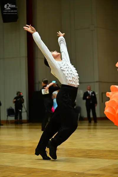 Dancesport competitor #58: Main dancer: white long-sleeved shirt with ruffles and black trousers