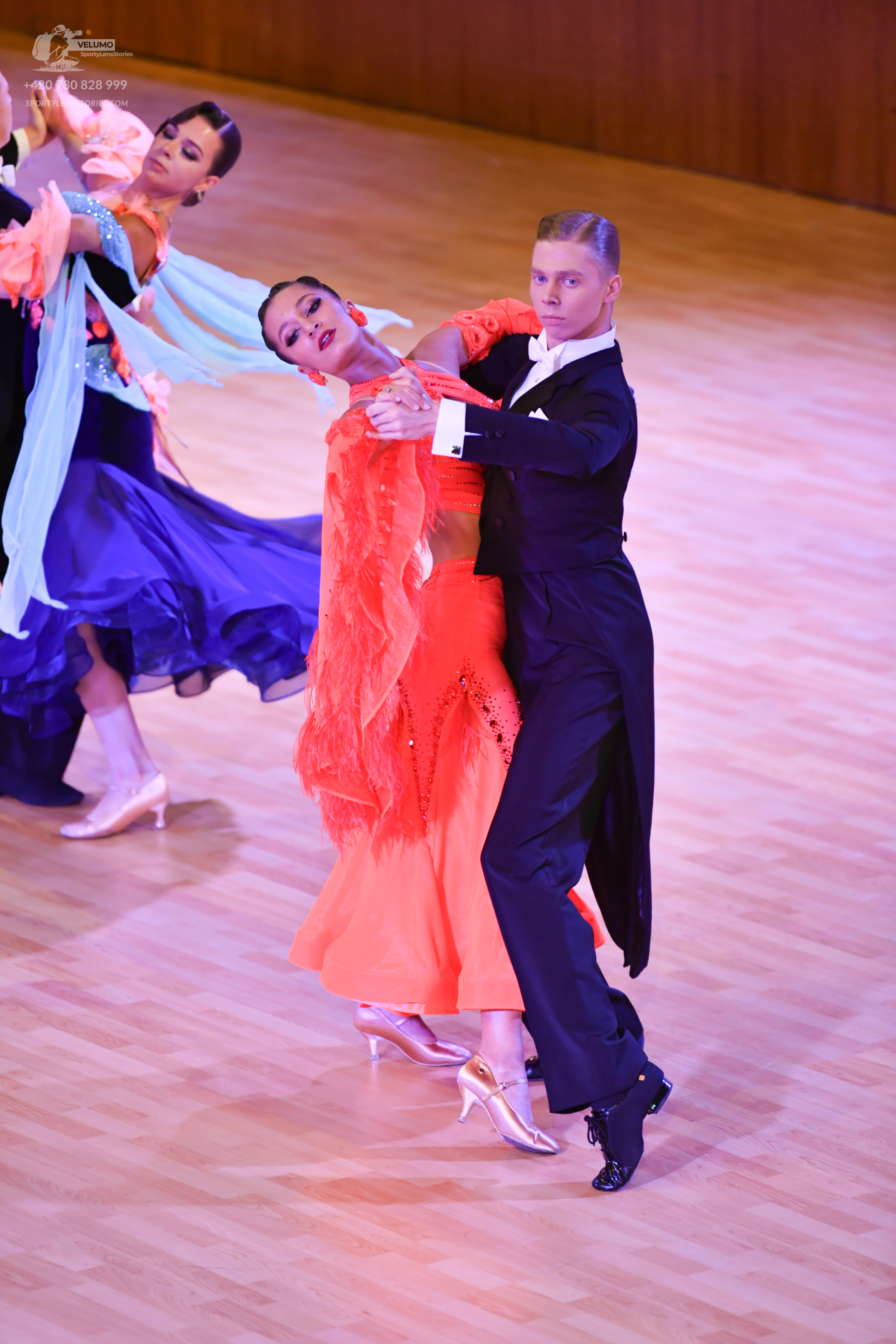 Dancesport competitor: ** Black tail suit with dark red sequin lapels and cuffs