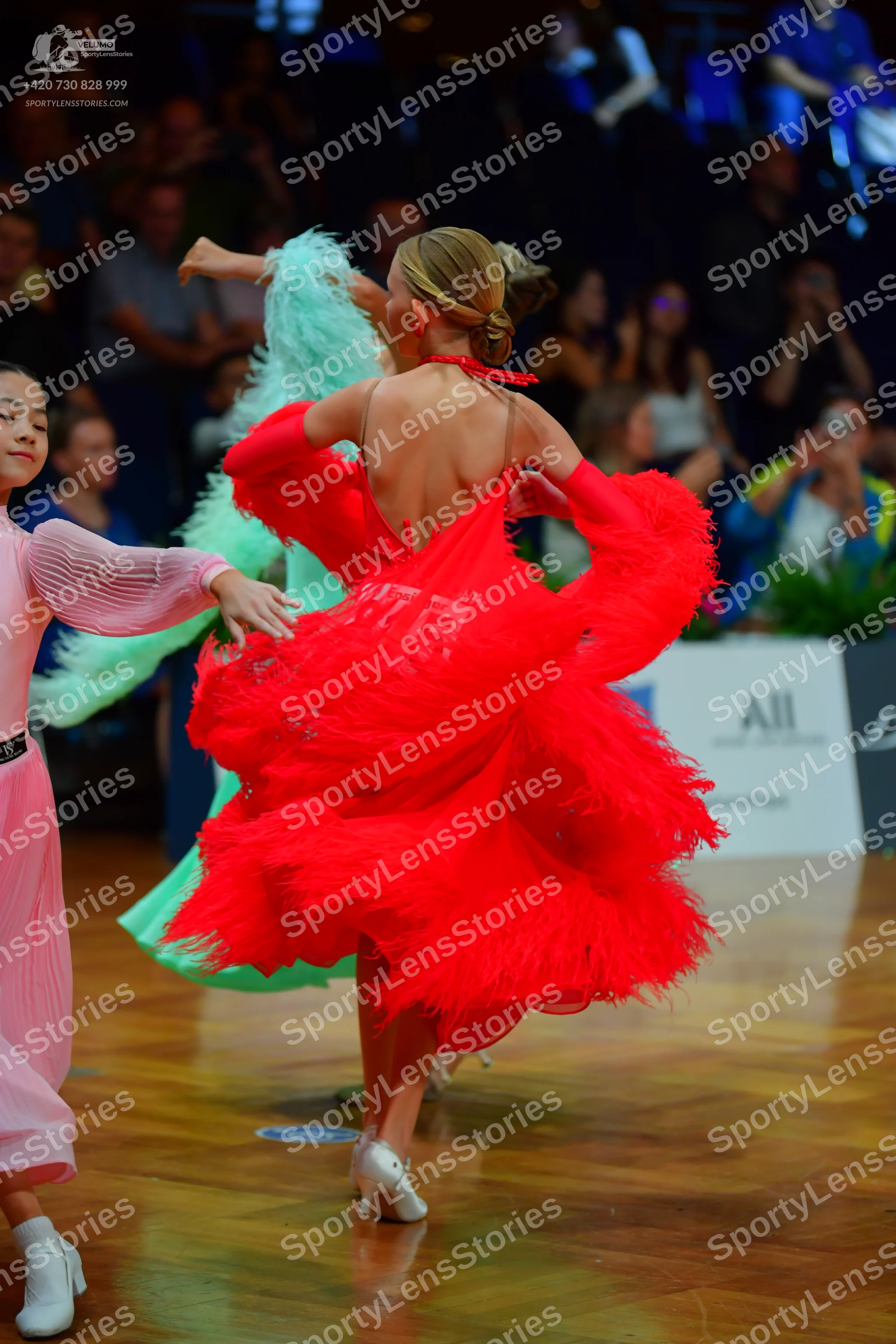 Dancesport competitor #145: Female dancer in red: red latin dress with voluminous layers of fringe