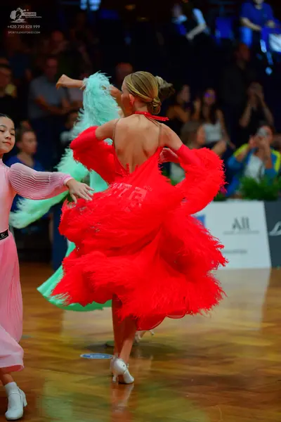 Dancesport competitor #145: Female dancer in red: red latin dress with voluminous layers of fringe