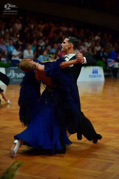 Dancesport competitor: Male dancer: black suit with a white shirt and black bowtie