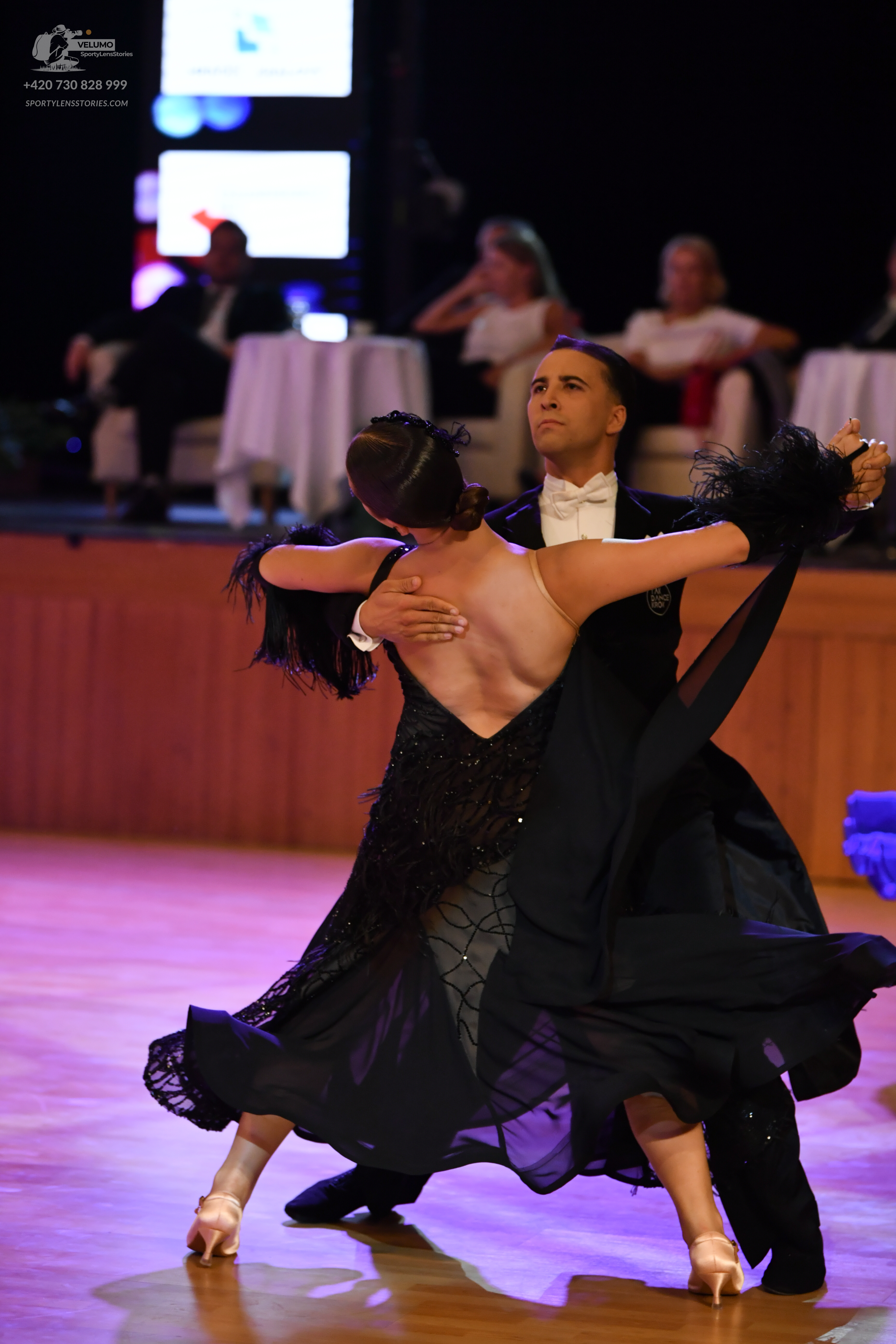 Dancesport competitor: Male dancer: black suit with a white shirt and white bow tie
