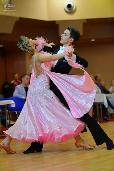 Dancesport competitor: Male dancer: black suit with a white shirt and white bowtie
