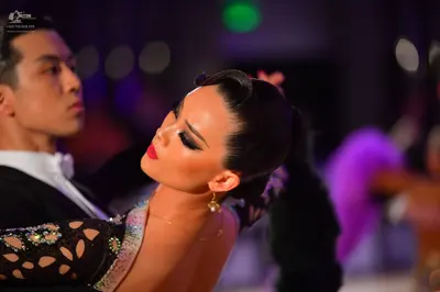 Dancesport competitor: Male dancer: black suit with a white shirt and white bowtie