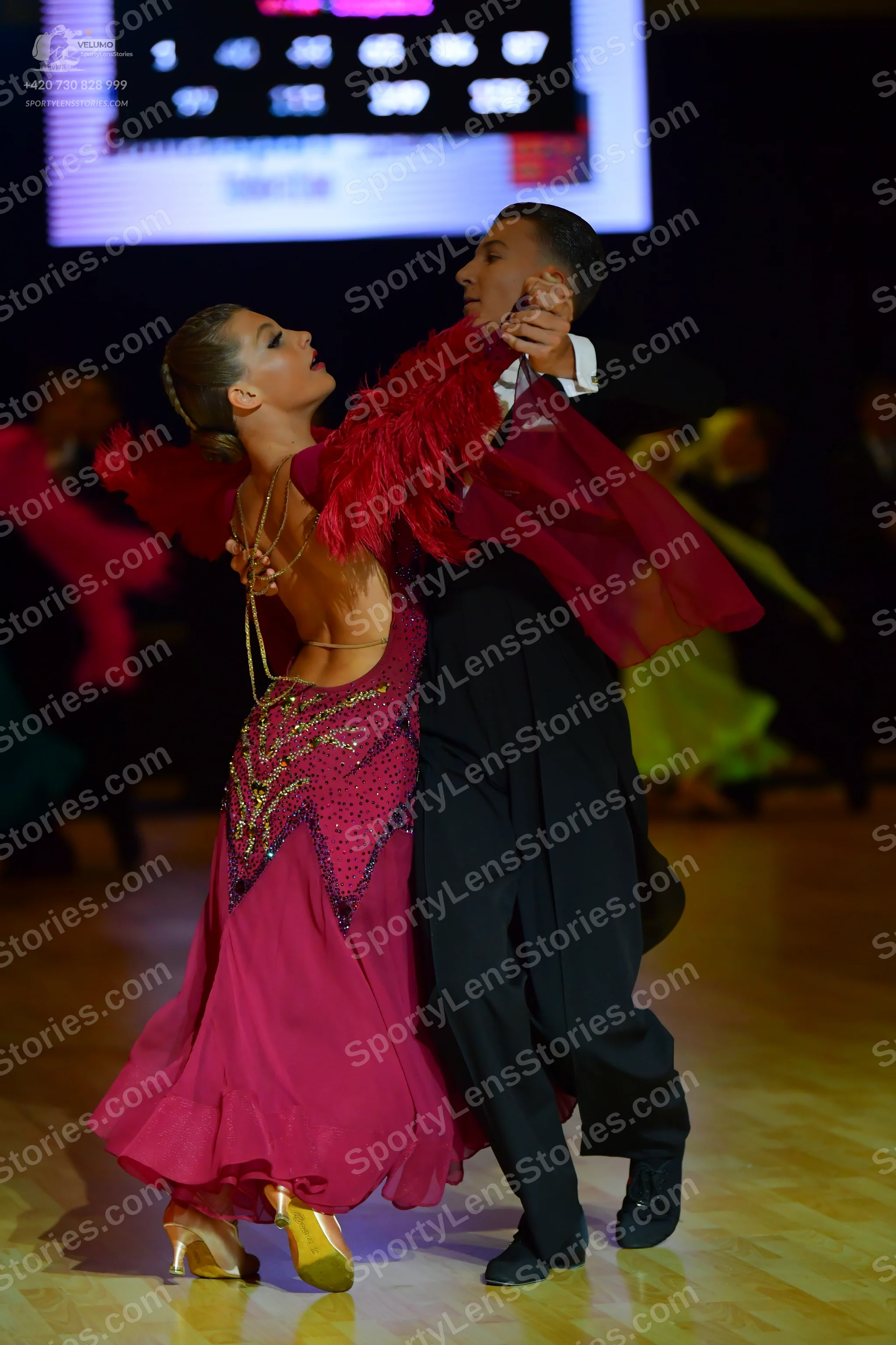 Dancesport competitor: Female dancer: pink/magenta latin dress with sequin embellishments on the bodice